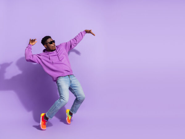 Full length profile photo of overjoyed carefree person stand tip toe dancing isolated on purple color background
